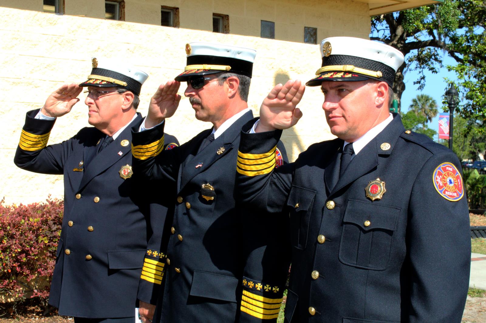 Fire chiefs in full uniform saluting