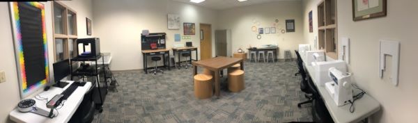 Panaramic vieew of the Maker Space at Orange Park Library with sewing machines, cricut, 3D printer, and tool desk