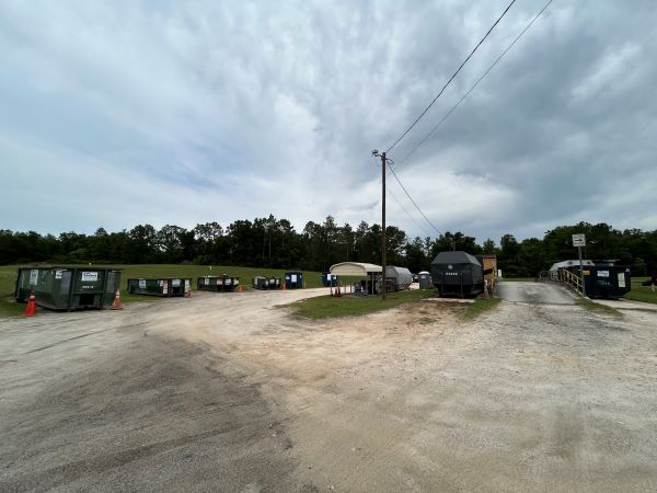 Blue background with "Clay County Solid Waste Facility Keystone Heights ECC Residential Waste Only Hours of Opreation 7:30 a.m. to 5:30 p.m. Thursday thru Saturday ORD.93-19