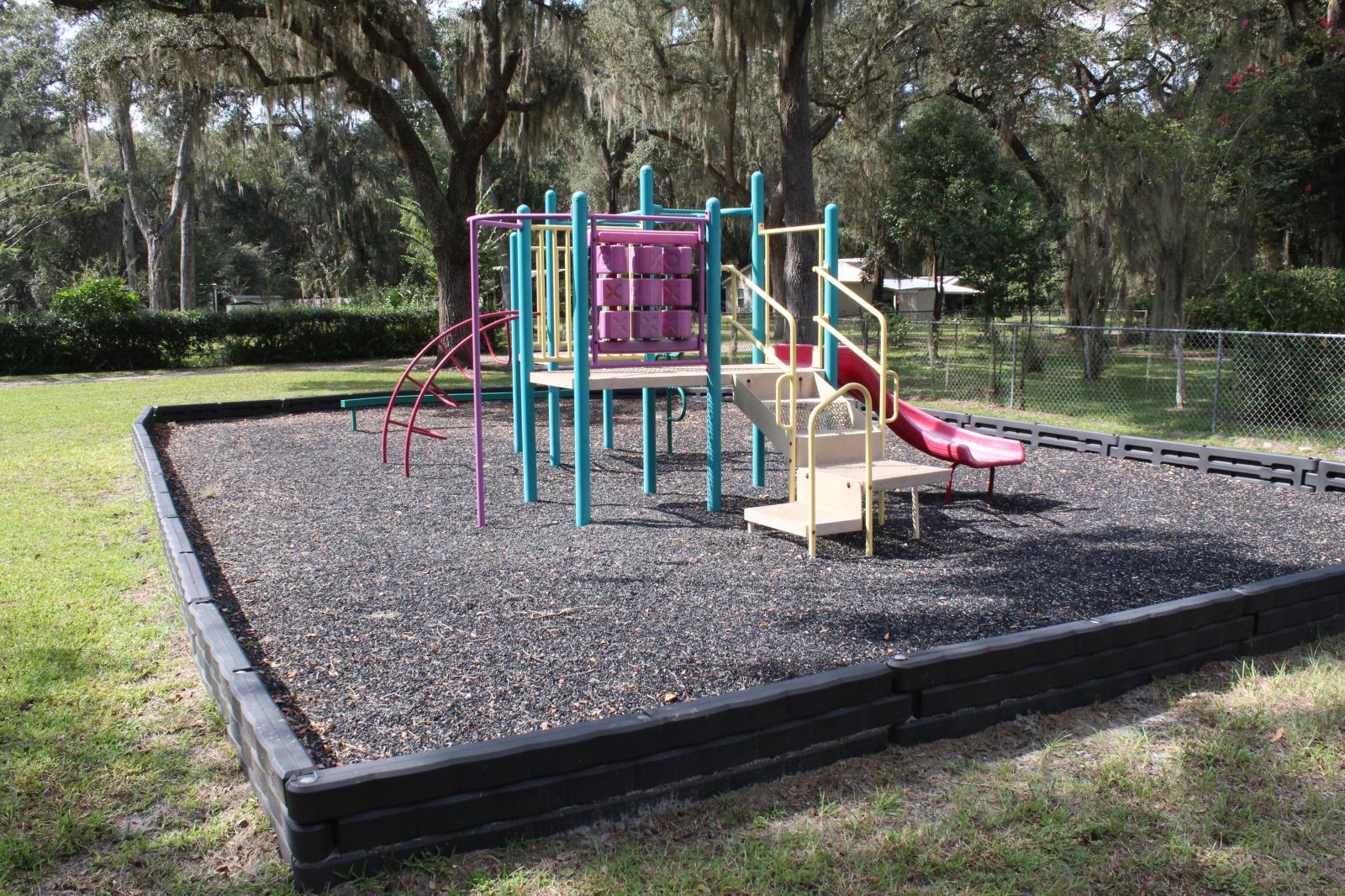 Small playground in raised bed with tire shreds