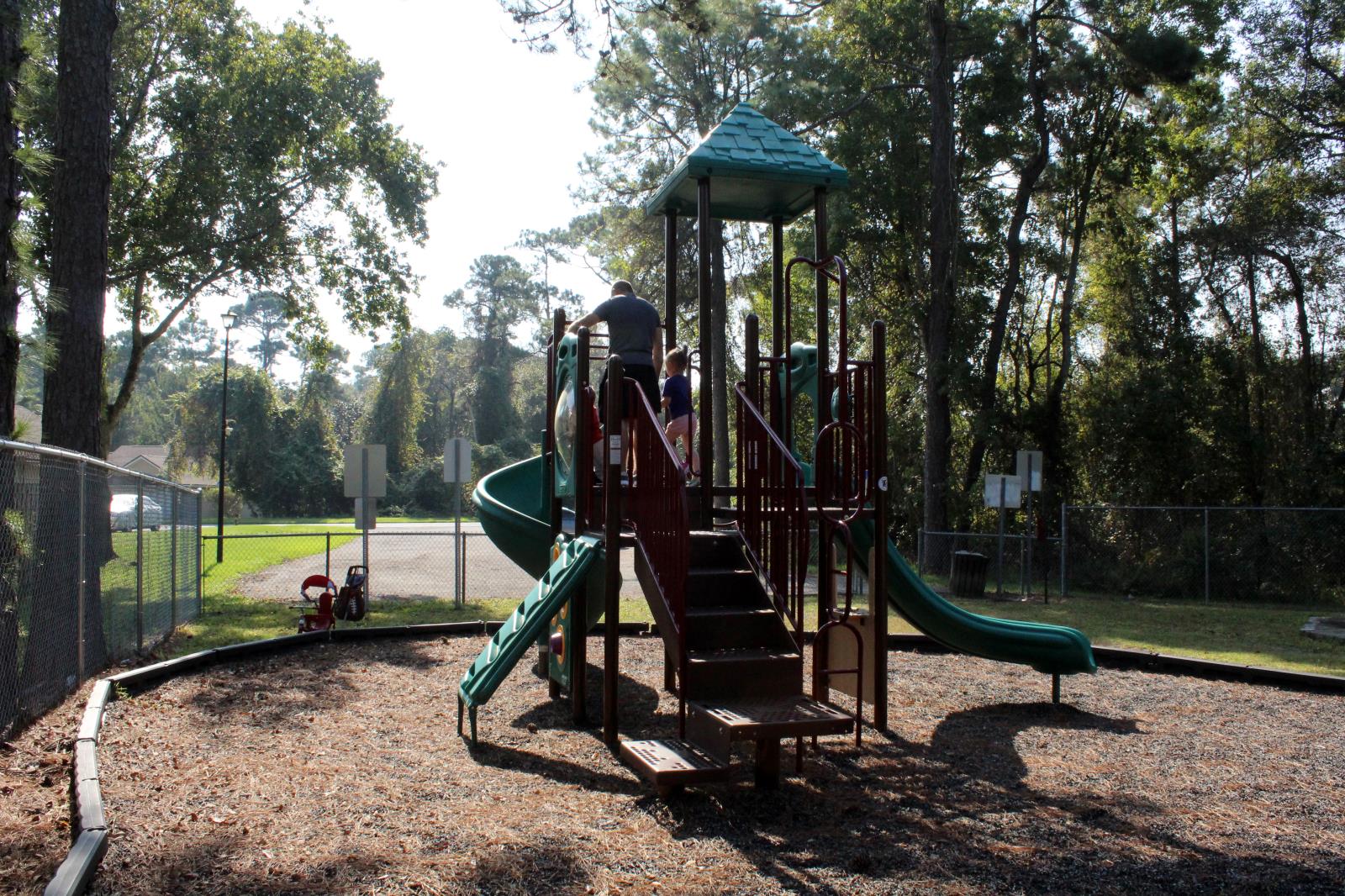 Playground equipment with a family playing on it