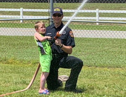 Fireman and boy straying water