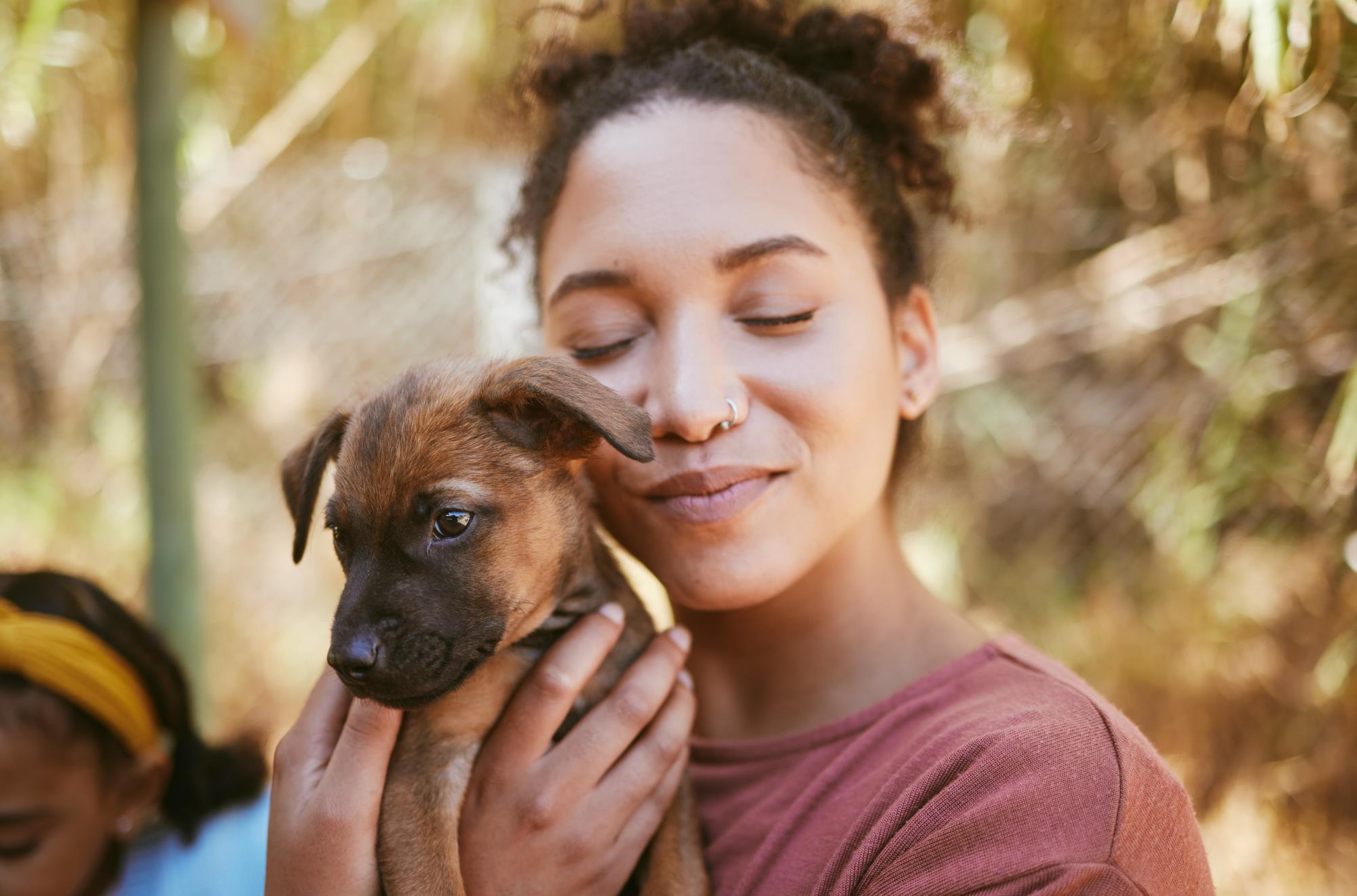 Woman snuggling a puppy