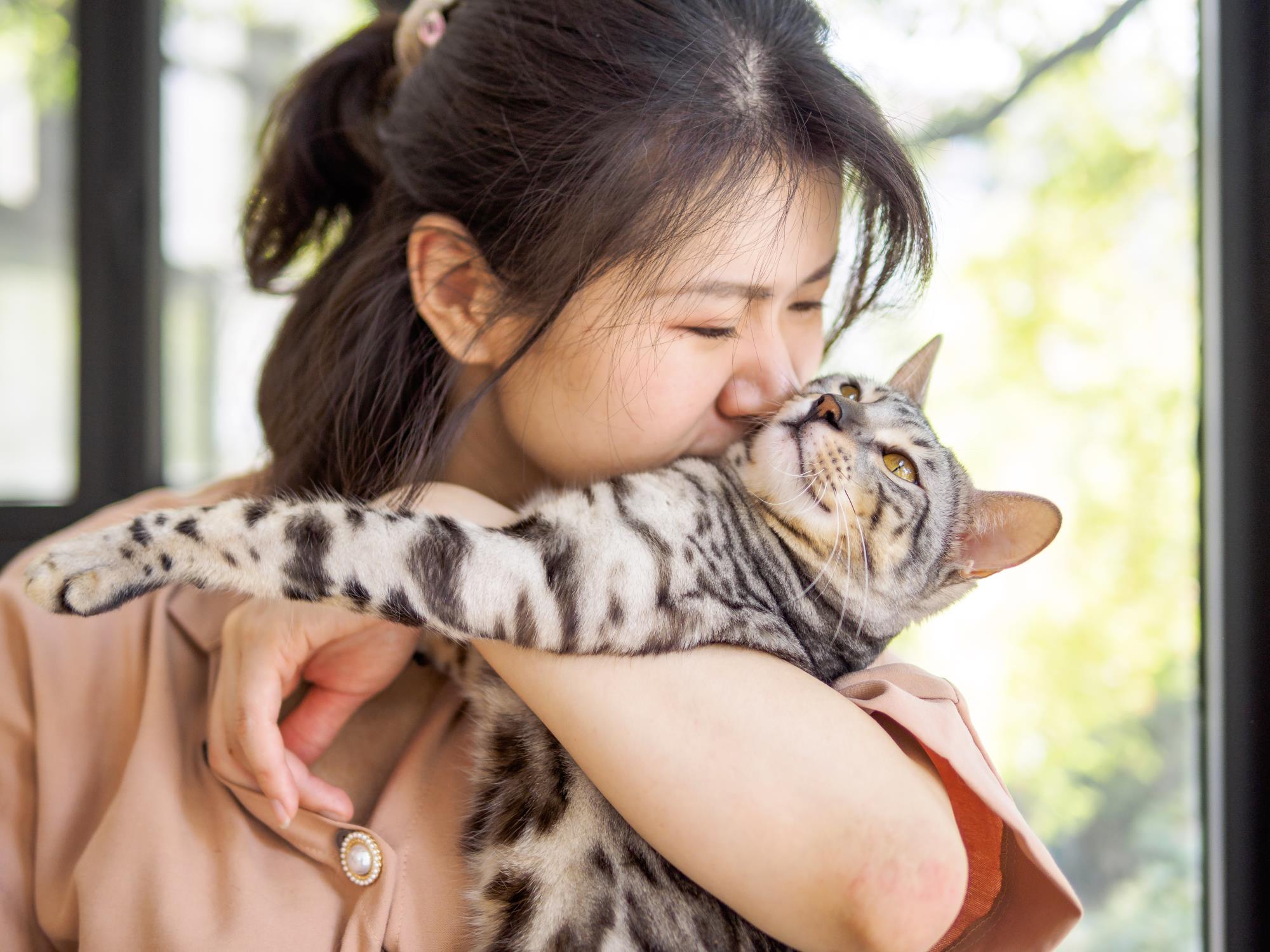 Woman snuggling a cat