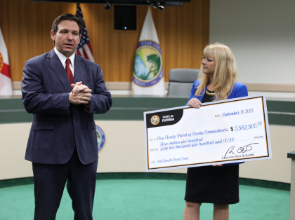 Governor DeSantis presents a check to the BCC