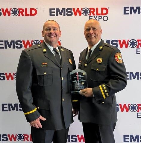 Firefighters holding  a plaque 