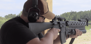 Man holding a gun at a range