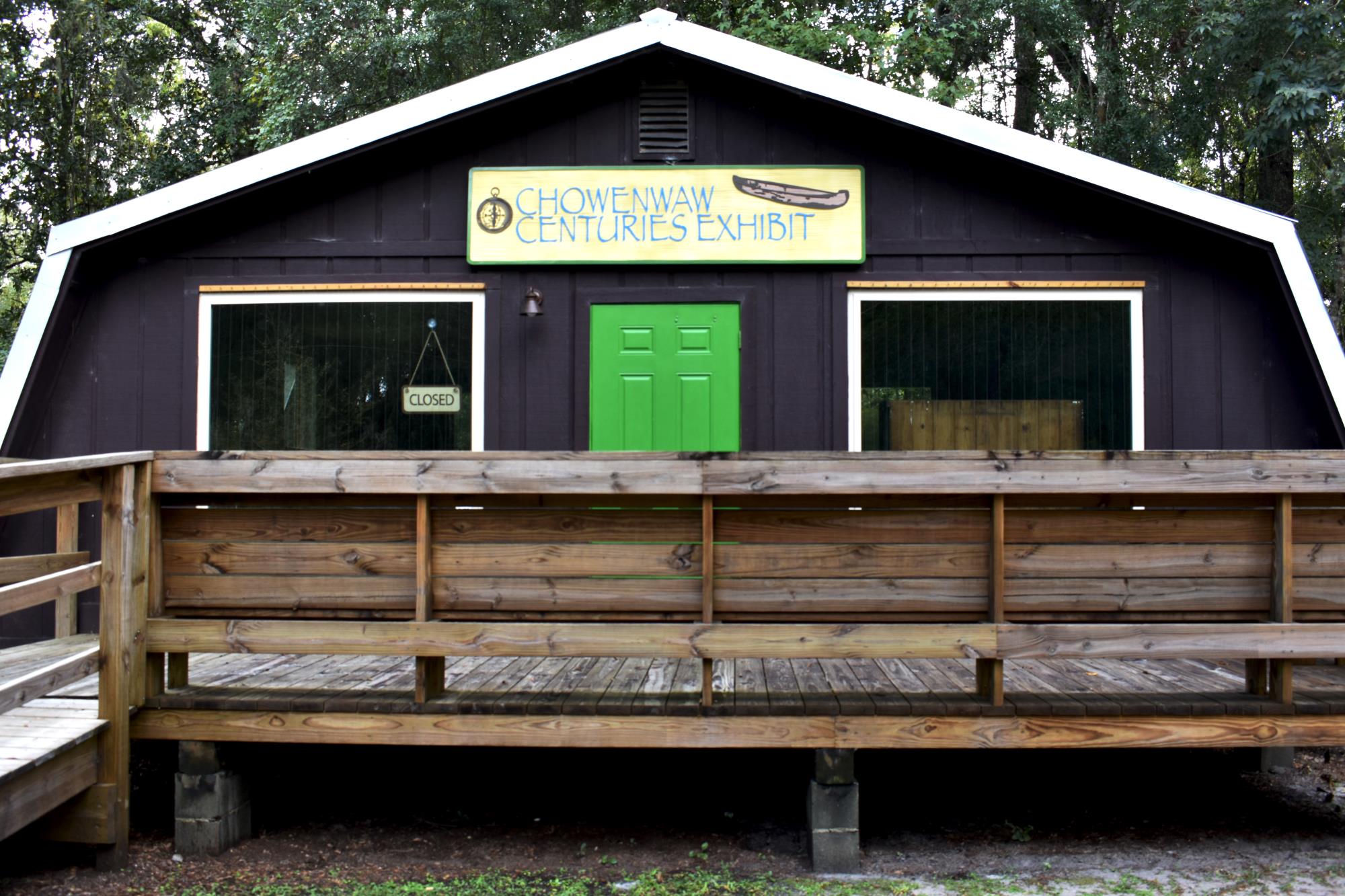 Wood cabin structure with the banner Camp Chowenwaw Centuries Exhibit