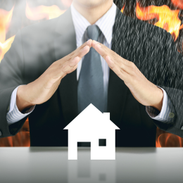 Man holding hands over a house protecting it from fire