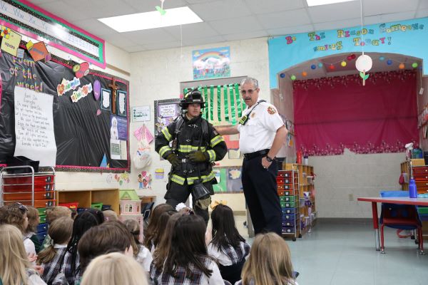 Firefighters with children at a school