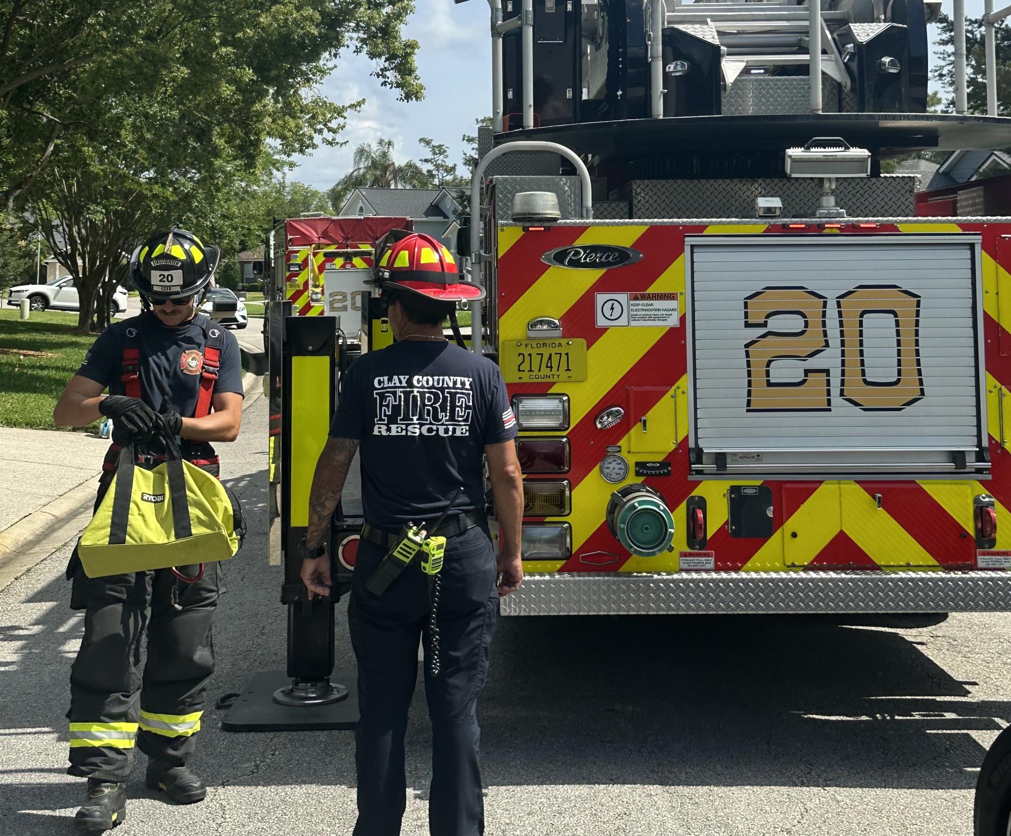 Firefighters wolking with Engine 20 in the background